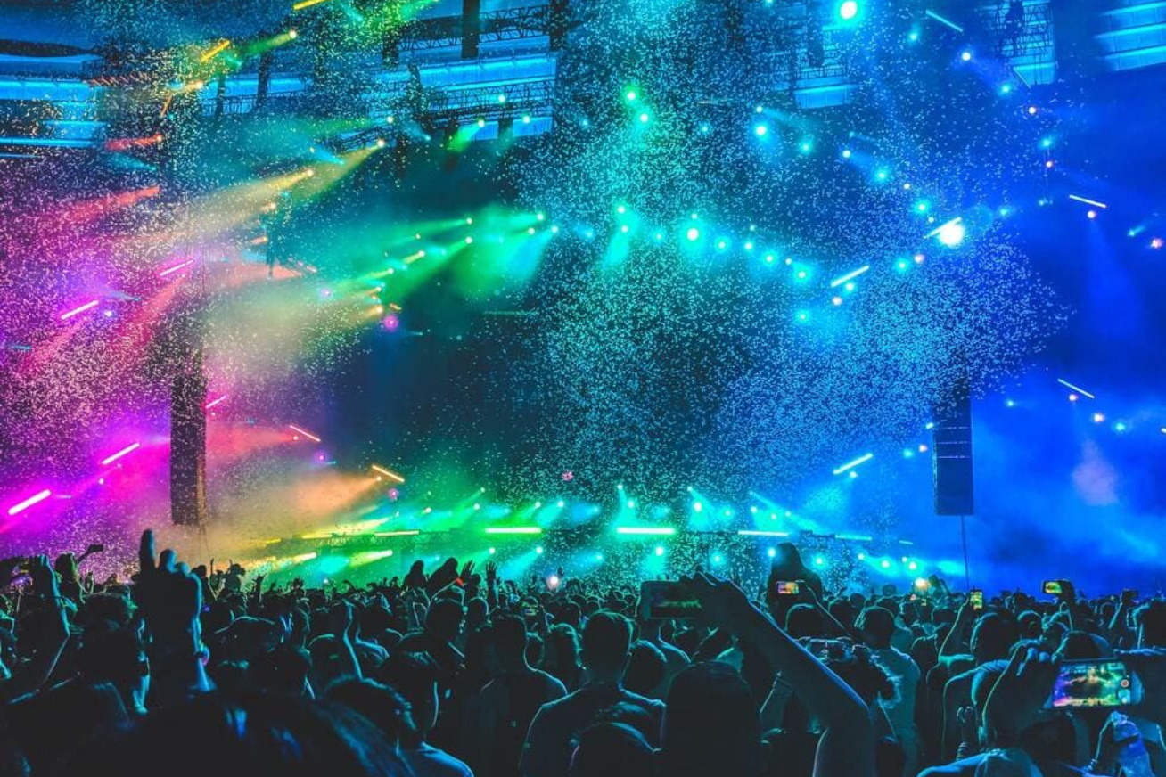 A crowd of people in front of a stage.